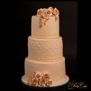 wedding cake with beige roses and lace